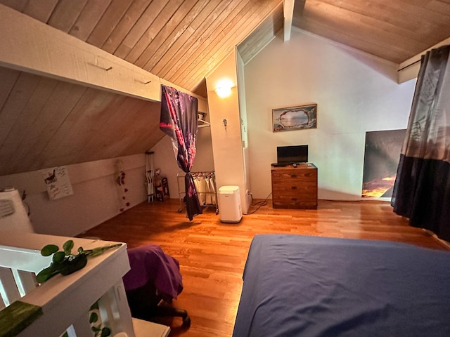 bedroom with hardwood / wood-style flooring, lofted ceiling with beams, and wooden ceiling