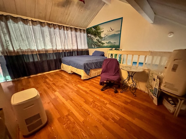 bedroom with lofted ceiling with beams, hardwood / wood-style floors, and wood ceiling