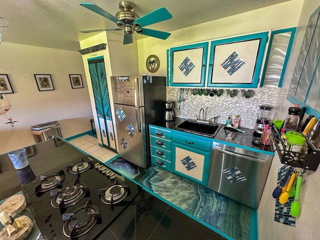 kitchen featuring backsplash, light tile patterned floors, stainless steel appliances, sink, and ceiling fan