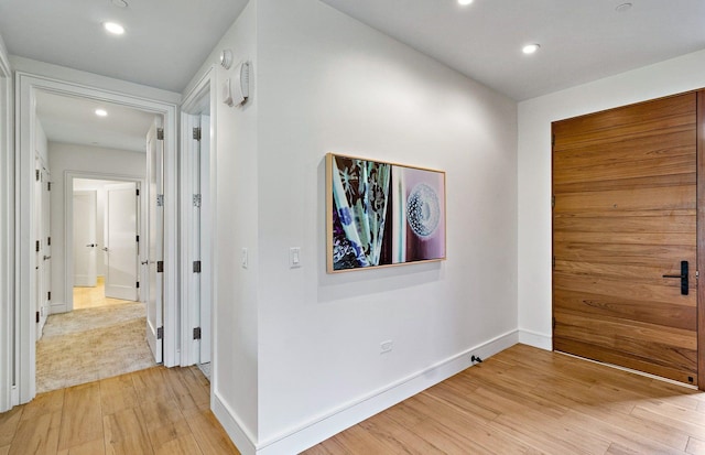 hallway with light hardwood / wood-style floors