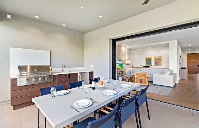 dining space with light tile patterned flooring and sink