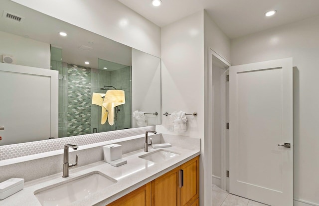 bathroom featuring tile patterned flooring, vanity, and walk in shower