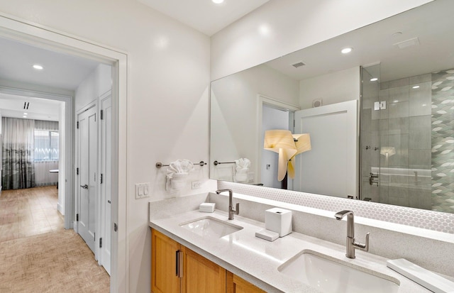 bathroom featuring vanity and a shower with door