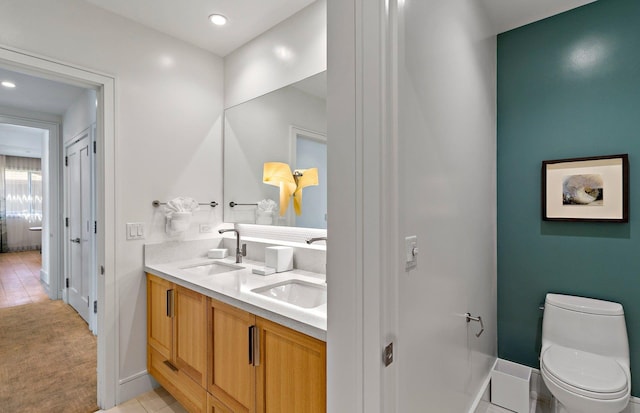 bathroom with tile patterned floors, vanity, and toilet