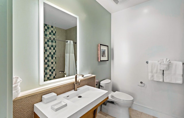 bathroom featuring tile patterned flooring, vanity, toilet, and walk in shower