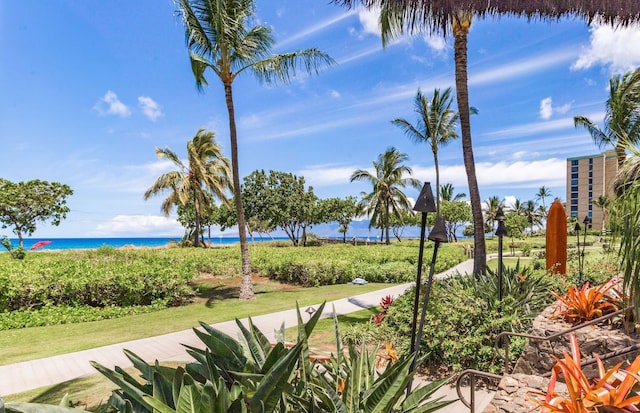 view of home's community featuring a lawn and a water view