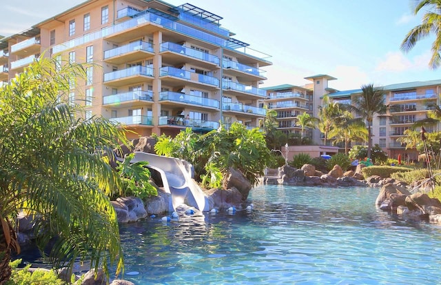 view of swimming pool featuring a water view