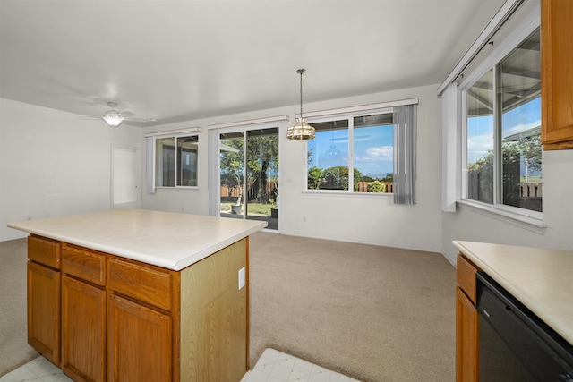 kitchen with black dishwasher, light colored carpet, a wealth of natural light, and decorative light fixtures