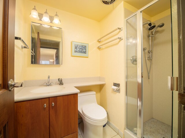 bathroom with tile patterned flooring, a shower with shower door, toilet, and vanity