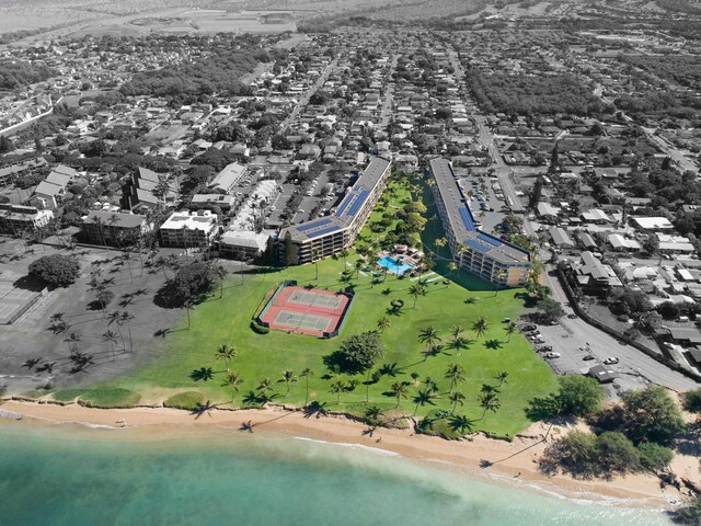 birds eye view of property with a beach view and a water view