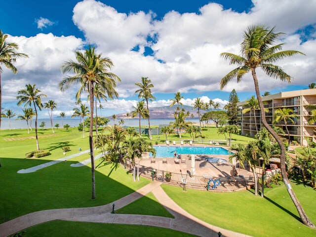 surrounding community featuring a water view, a swimming pool, a lawn, and a patio