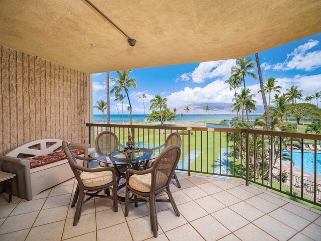 view of patio / terrace with a water view and a balcony