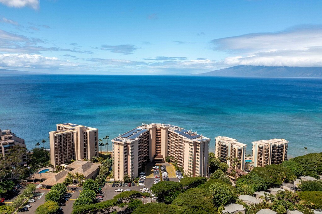 birds eye view of property featuring a water and mountain view