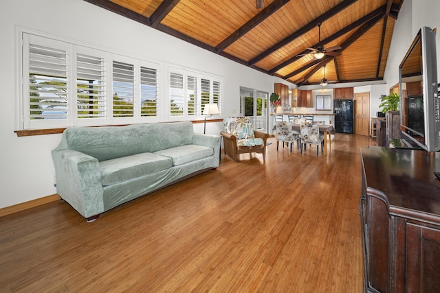 living room with vaulted ceiling with beams, hardwood / wood-style flooring, a wealth of natural light, and wood ceiling