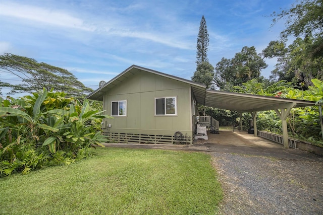 view of home's exterior with a yard and a carport