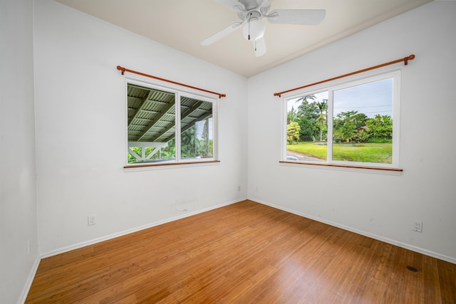 unfurnished room with ceiling fan and hardwood / wood-style floors