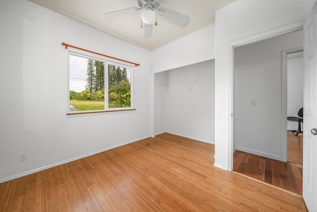 unfurnished bedroom featuring a closet, light hardwood / wood-style floors, and ceiling fan