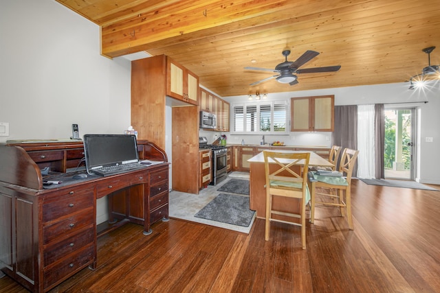 kitchen with appliances with stainless steel finishes, wood ceiling, ceiling fan, a center island, and dark hardwood / wood-style floors