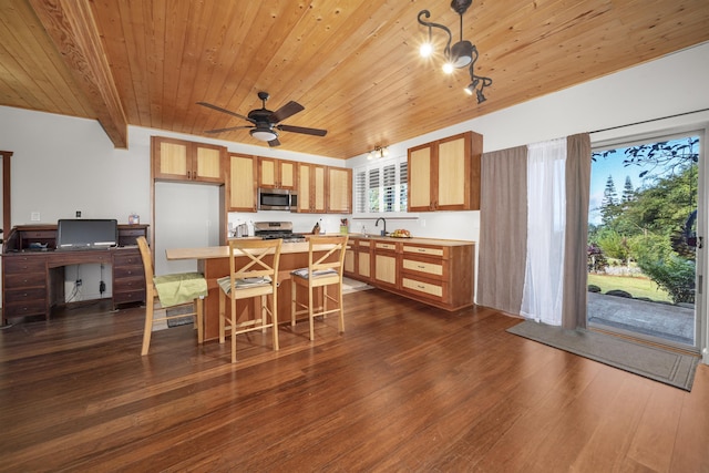 kitchen with a center island, wooden ceiling, appliances with stainless steel finishes, beam ceiling, and dark hardwood / wood-style flooring