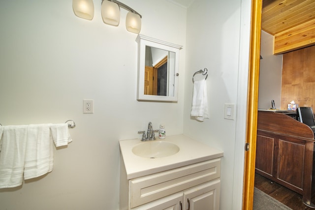 bathroom featuring wooden ceiling, vanity, and wood-type flooring