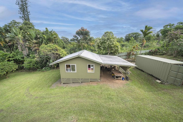 exterior space with a lawn and an outdoor structure