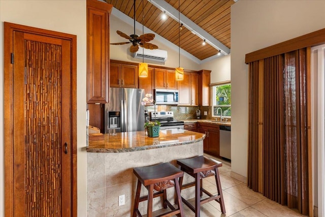 kitchen with wood ceiling, an AC wall unit, a kitchen breakfast bar, stainless steel appliances, and decorative light fixtures