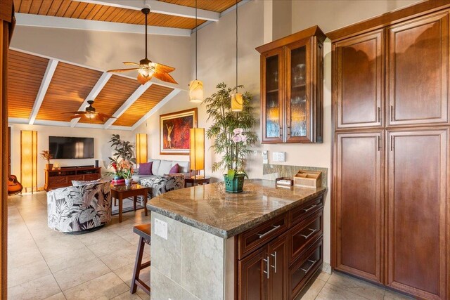 kitchen with a kitchen breakfast bar, lofted ceiling with beams, wood ceiling, and ceiling fan