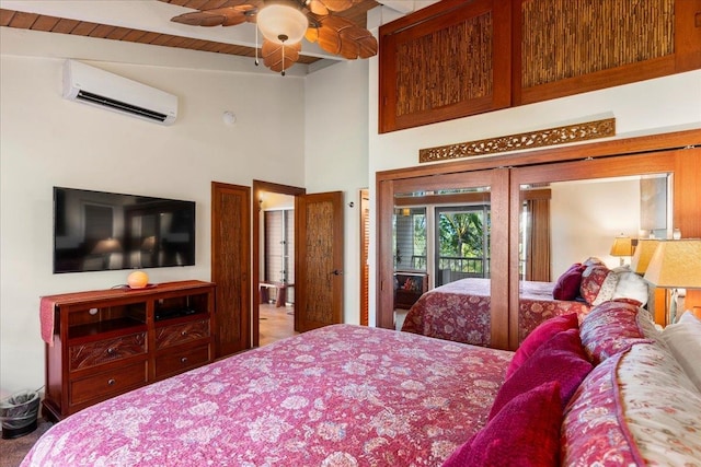 bedroom with a wall unit AC, access to exterior, a high ceiling, and ceiling fan