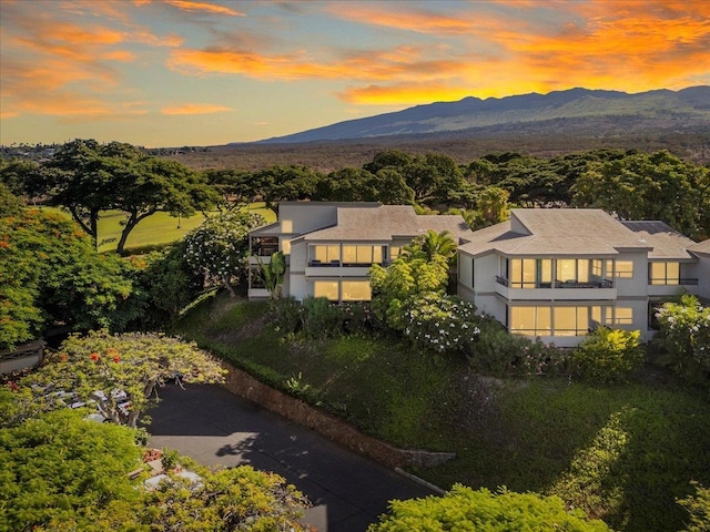 aerial view at dusk featuring a mountain view