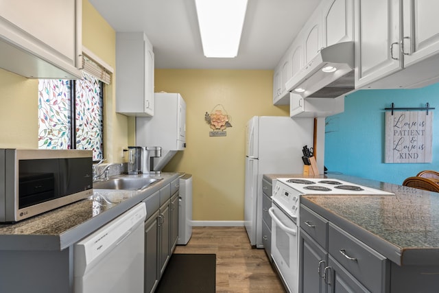 kitchen with sink, white appliances, hardwood / wood-style flooring, and gray cabinets