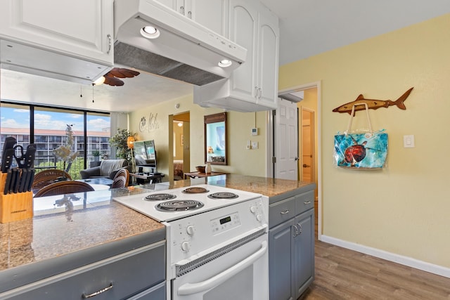 kitchen featuring white range with electric stovetop, gray cabinetry, hardwood / wood-style flooring, and white cabinetry