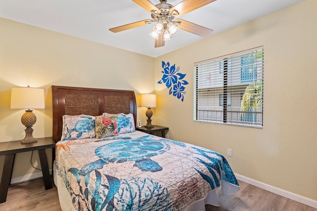 bedroom with wood-type flooring and ceiling fan