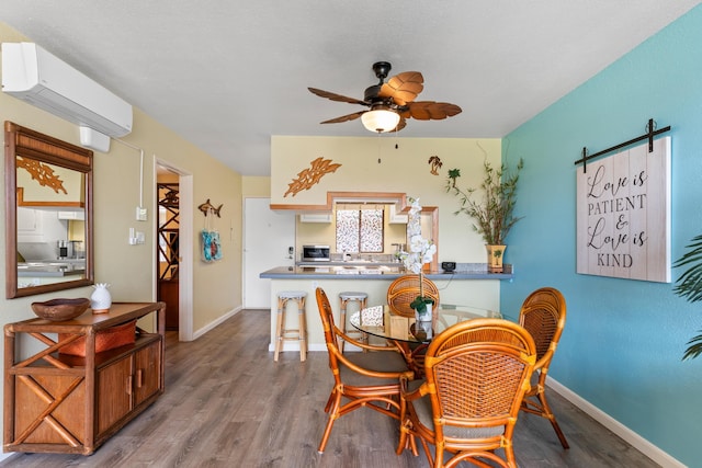 dining area featuring hardwood / wood-style floors, a wall unit AC, and ceiling fan