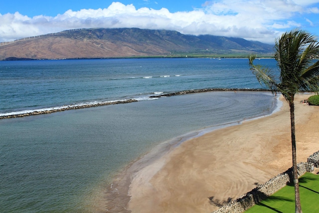 view of water feature featuring a view of the beach and a mountain view