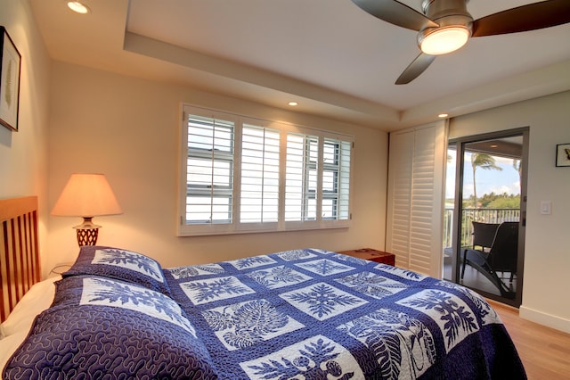 bedroom with light hardwood / wood-style flooring, access to exterior, ceiling fan, and multiple windows