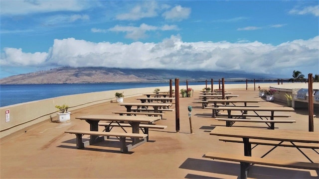 surrounding community with a water and mountain view