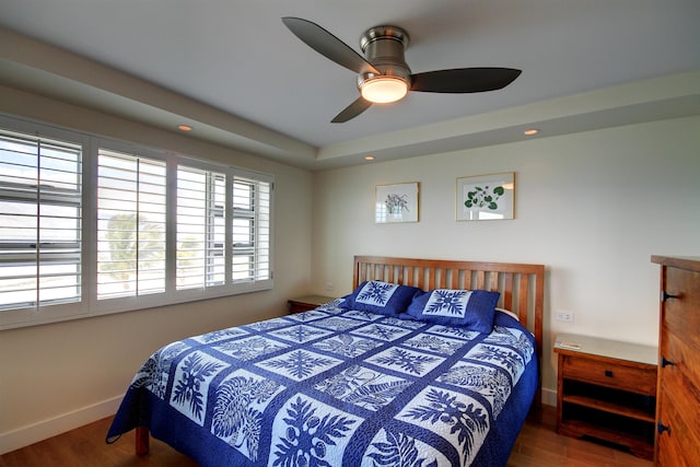 bedroom with ceiling fan and dark wood-type flooring