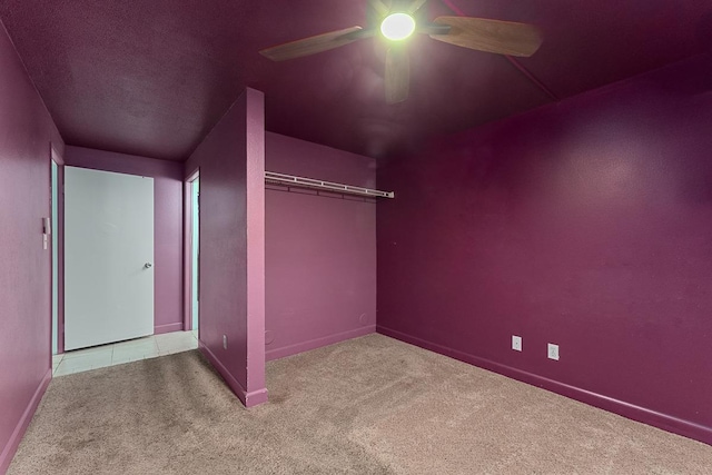 2747 S Kihei Rd Unit D102, Kihei, HI 96753 - unfurnished bedroom featuring carpet floors, baseboards, a ceiling fan, and a closet