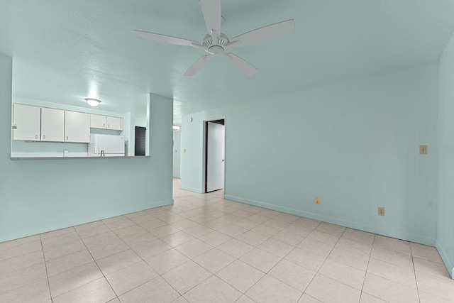 2747 S Kihei Rd Unit D102, Kihei, HI 96753 - unfurnished living room with a ceiling fan, baseboards, and light tile patterned flooring