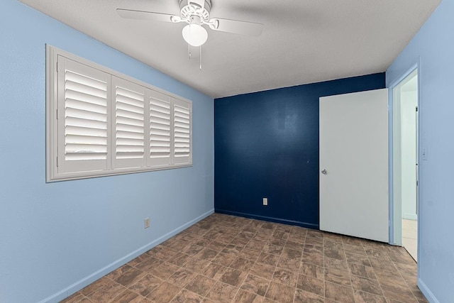 2747 S Kihei Rd Unit D102, Kihei, HI 96753 - empty room with ceiling fan, baseboards, and stone finish floors