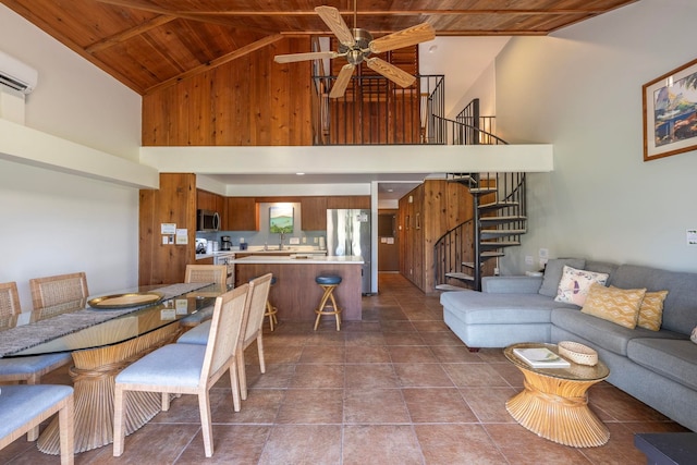 interior space with ceiling fan, tile flooring, wood ceiling, and high vaulted ceiling