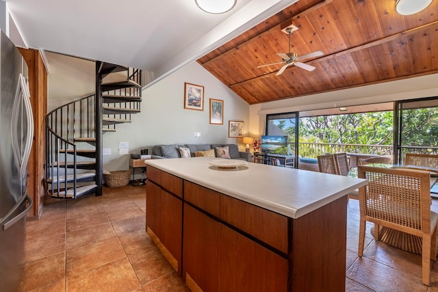 kitchen with ceiling fan, a healthy amount of sunlight, light tile flooring, and wood ceiling