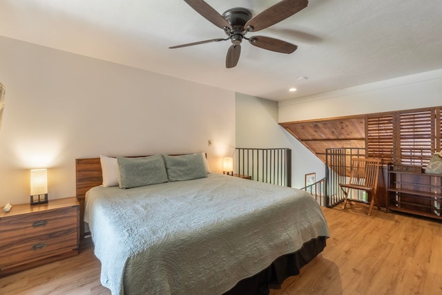 bedroom with ceiling fan and light hardwood / wood-style floors