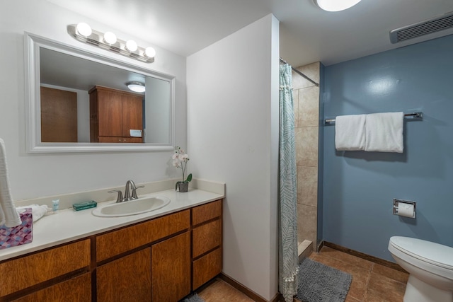 bathroom featuring tile floors, a shower with curtain, toilet, and vanity