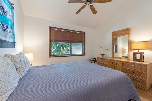 bedroom featuring ceiling fan, light wood-type flooring, and lofted ceiling