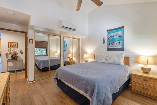 bedroom with a wall unit AC, light wood-type flooring, vaulted ceiling, and ceiling fan