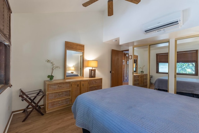 bedroom with a wall mounted AC, high vaulted ceiling, ceiling fan, and hardwood / wood-style floors