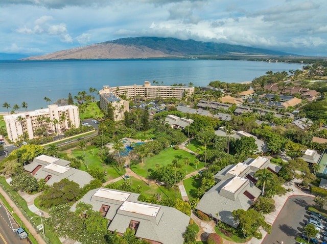 drone / aerial view featuring a water and mountain view