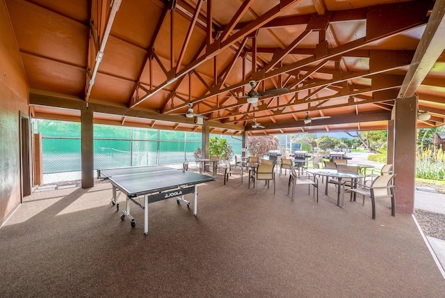 exterior space featuring vaulted ceiling and carpet flooring