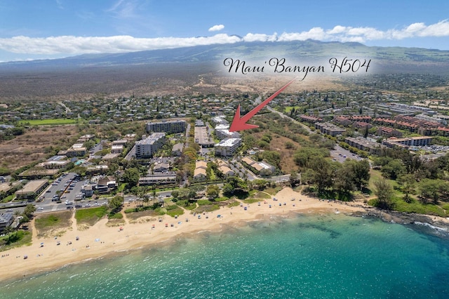 drone / aerial view featuring a water view and a beach view